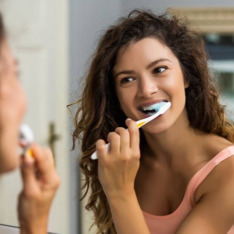 Brush twice daily and floss carefully, especially around the gumline